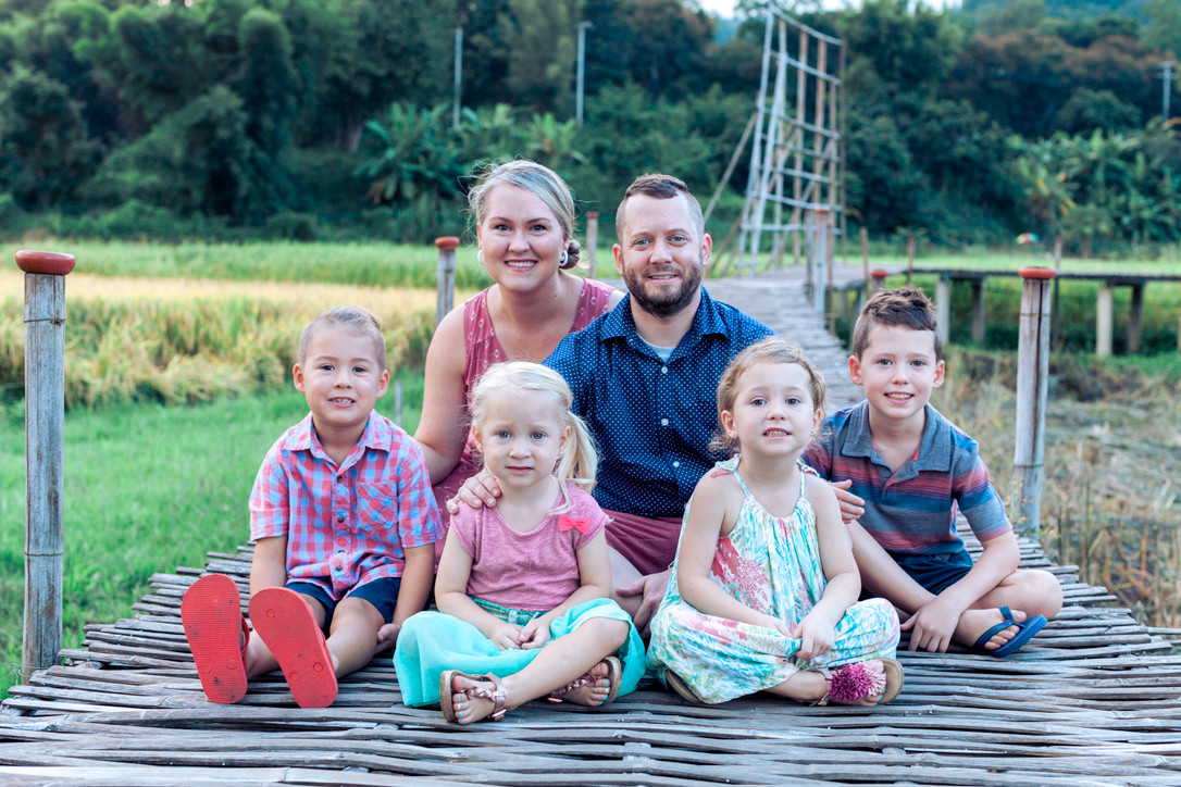 The Derington family together beside rice fields